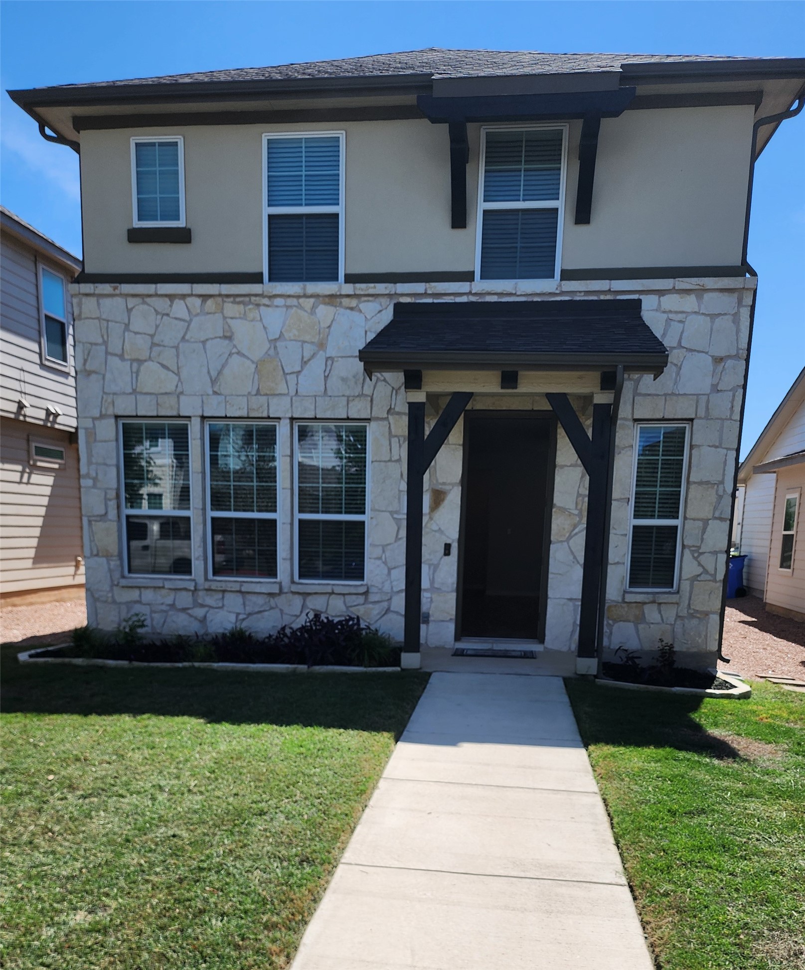 182 McKittrick Ridge Street Dripping Springs, TX 78620 - Photo 1 of 1 View of front of house with stone siding, a front lawn, and stucco siding