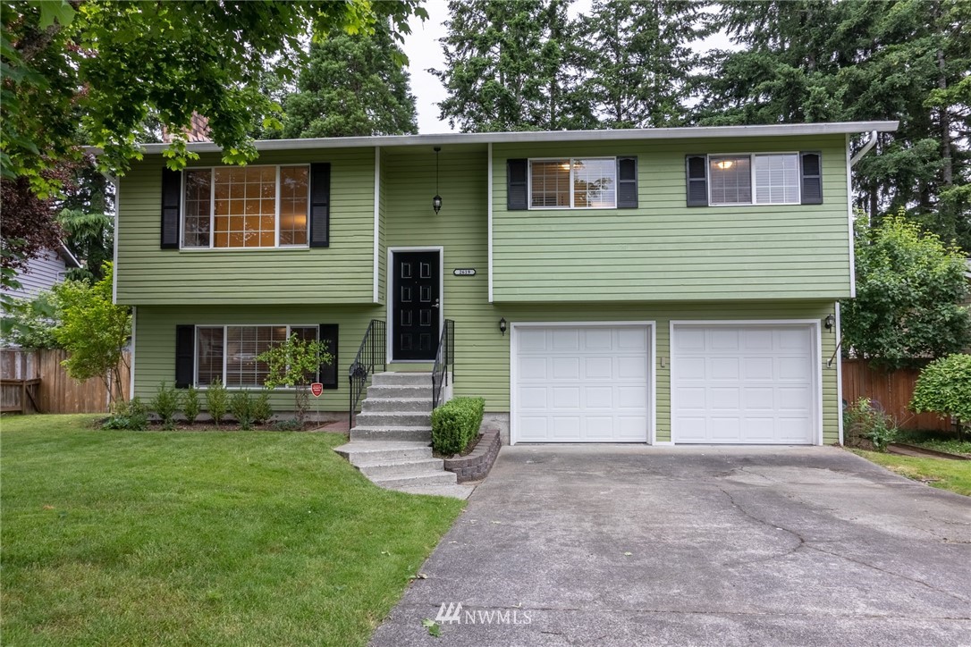 2619 164th Place Southeast Bothell, WA 98012 - Photo 1 of 19 a front view of a house with garden