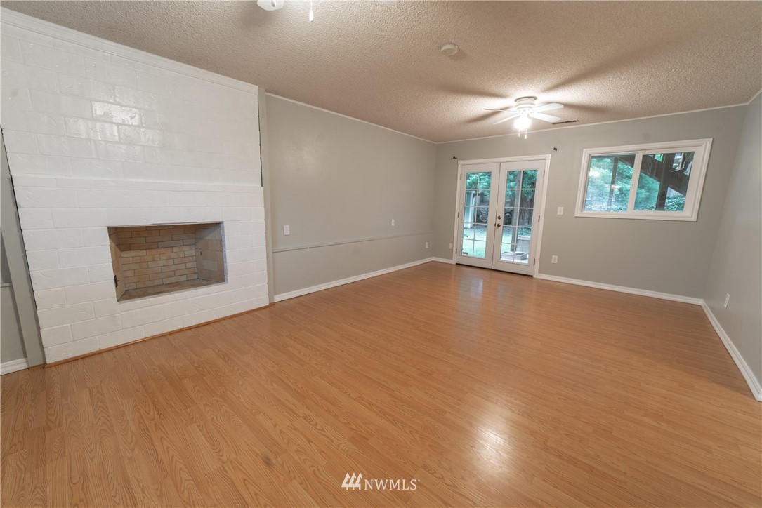 2619 164th Place Southeast Bothell, WA 98012 - Photo 14 of 19 a view of an empty room with window and wooden floor