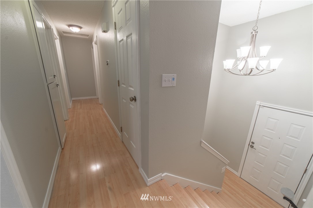 2619 164th Place Southeast Bothell, WA 98012 - Photo 4 of 19 a view of a hallway with wooden floor