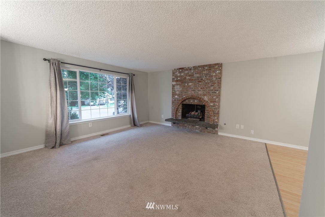 2619 164th Place Southeast Bothell, WA 98012 - Photo 6 of 19 an empty room with fireplace and a window