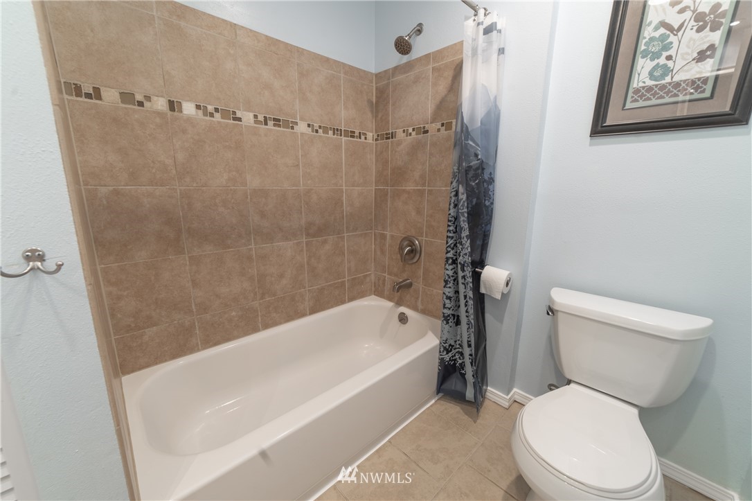 2619 164th Place Southeast Bothell, WA 98012 - Photo 7 of 19 a white toilet sitting next to a bath tub
