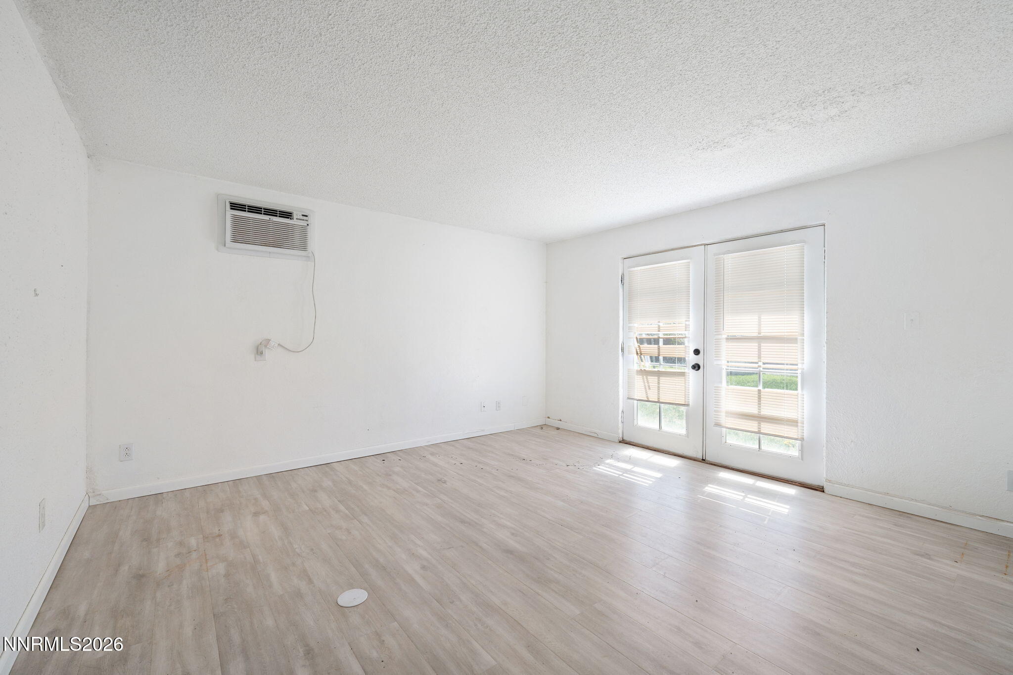 3590 Siskin Lane Reno, NV 89508 - Photo 20 of 31 a view of an empty room with wooden floor and a window