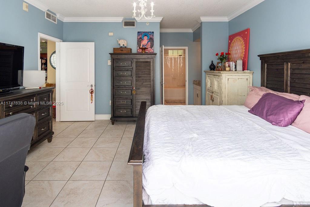 7270 Southwest 88th Street, Unit B308 Miami, FL 33156 - Photo 12 of 38 a spacious bedroom with a bed cabinets and window