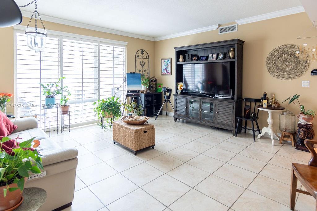 7270 Southwest 88th Street, Unit B308 Miami, FL 33156 - Photo 15 of 38 a living room with furniture and a flat screen tv