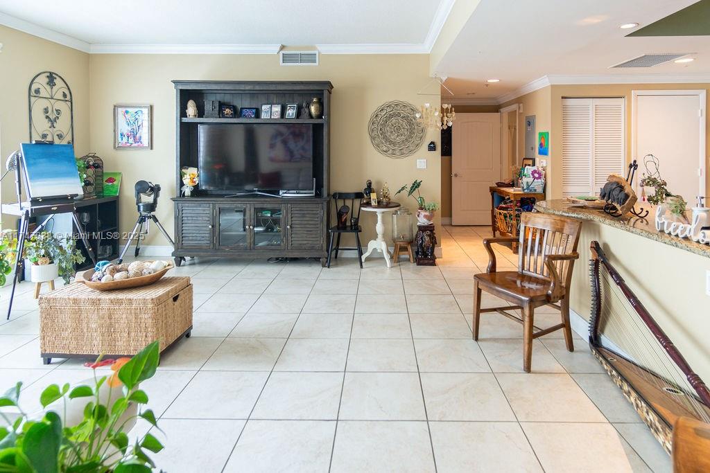7270 Southwest 88th Street, Unit B308 Miami, FL 33156 - Photo 18 of 38 a living room with furniture and a flat screen tv