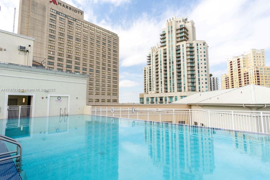 7270 Southwest 88th Street, Unit B308 Miami, FL 33156 - Photo 31 of 38 a view of open kitchen with stainless steel appliances wooden floor and furniture