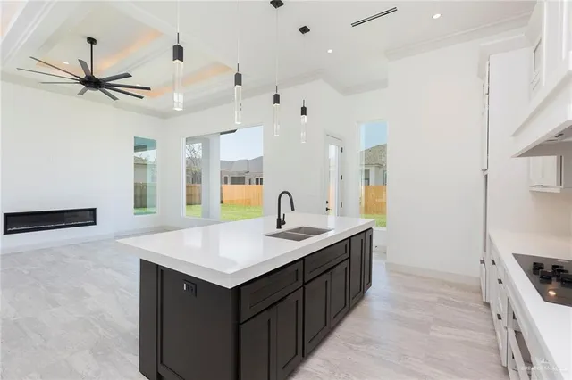 a kitchen with a sink dishwasher and a stove with wooden floor