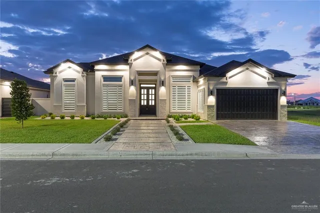 a front view of a house with a yard and garage