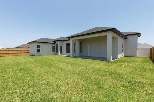 a front view of house with yard and garage