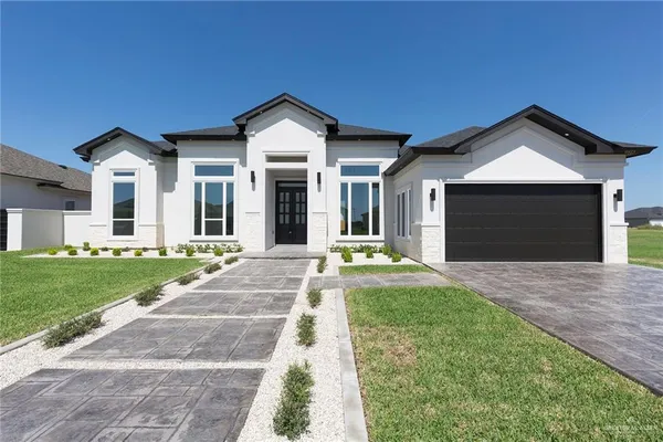 a front view of a house with a yard and garage