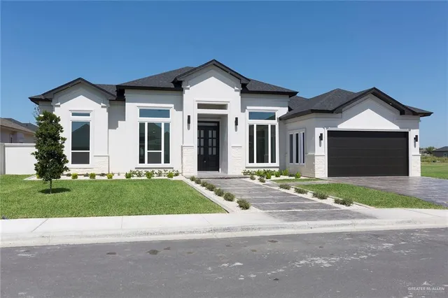 a front view of house with a yard and garage