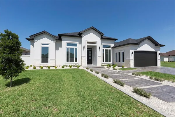 a front view of a house with a yard and garage