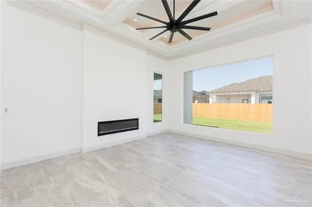 an empty room with window and a ceiling fan