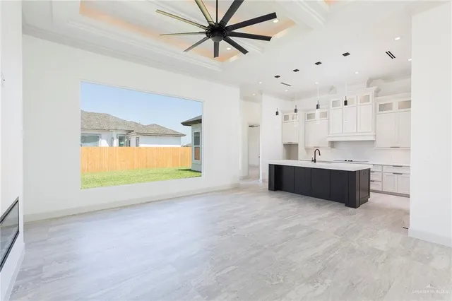 a living room with kitchen island furniture and a ceiling fan