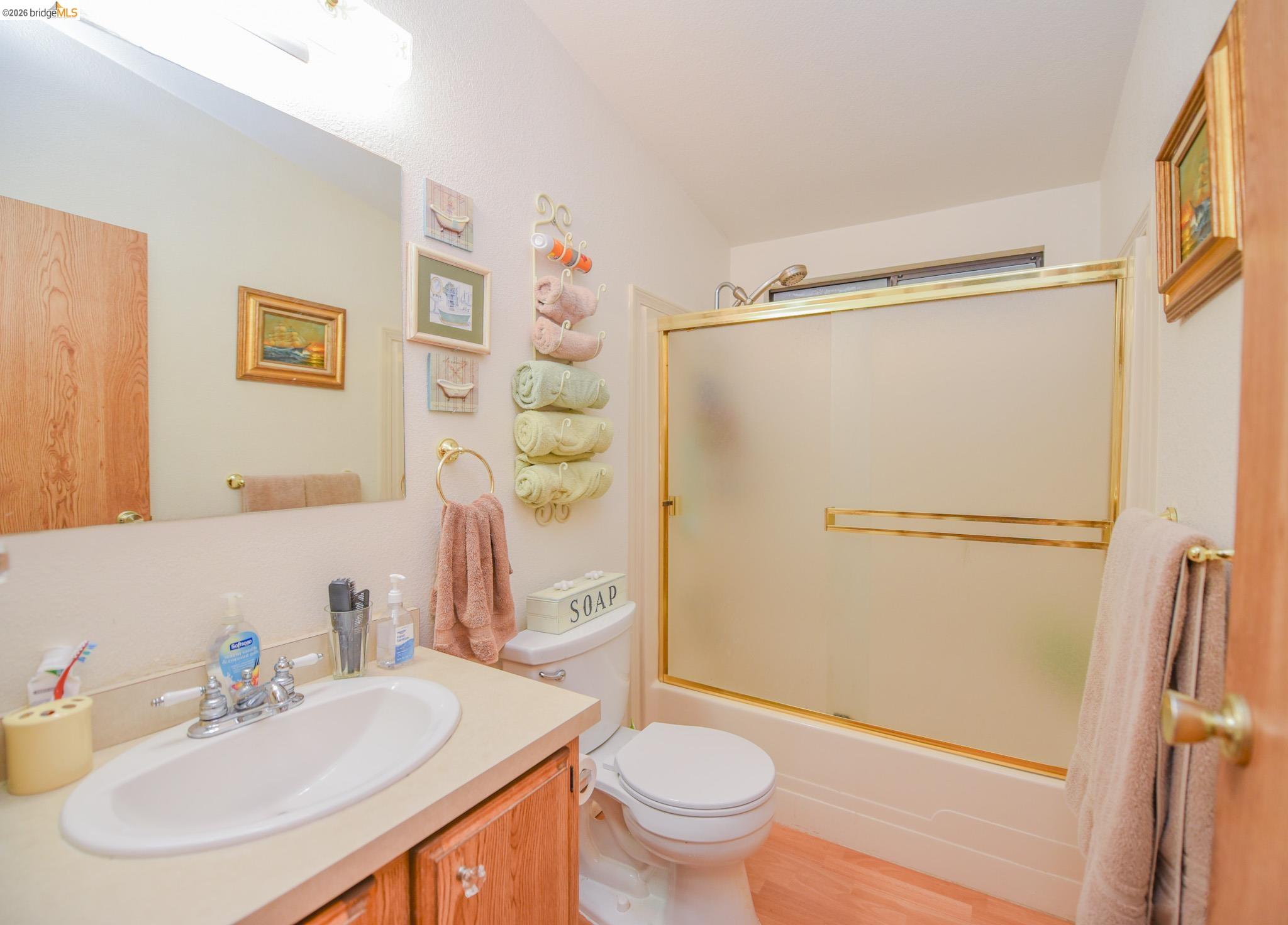 18717 Mill Villa Road, Unit 235 Jamestown, CA 95327 - Photo 17 of 26 Bathroom featuring vanity, enclosed tub / shower combo, and wood finished floors
