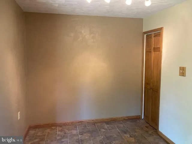 a kitchen with a sink a granite counter top and dining room