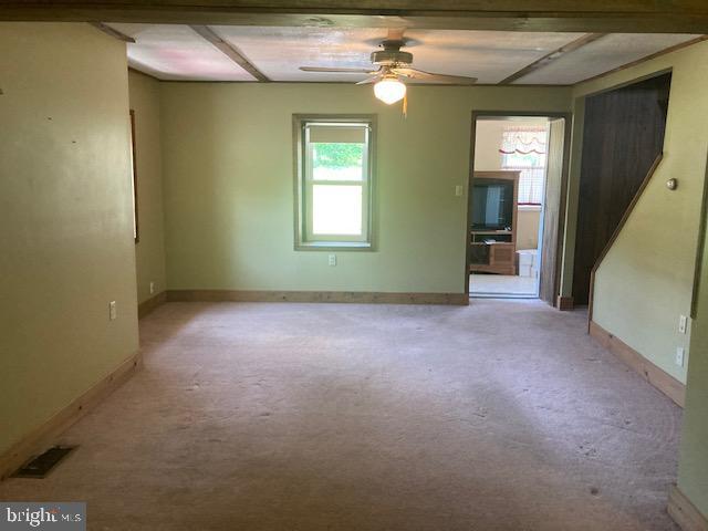 4865 Spruce Creek Road Spruce Creek, PA 16683 - Photo 14 of 46 an empty room with a fan and windows