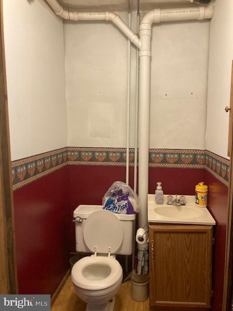 4865 Spruce Creek Road Spruce Creek, PA 16683 - Photo 17 of 46 a bathroom with a toilet a sink and a mirror