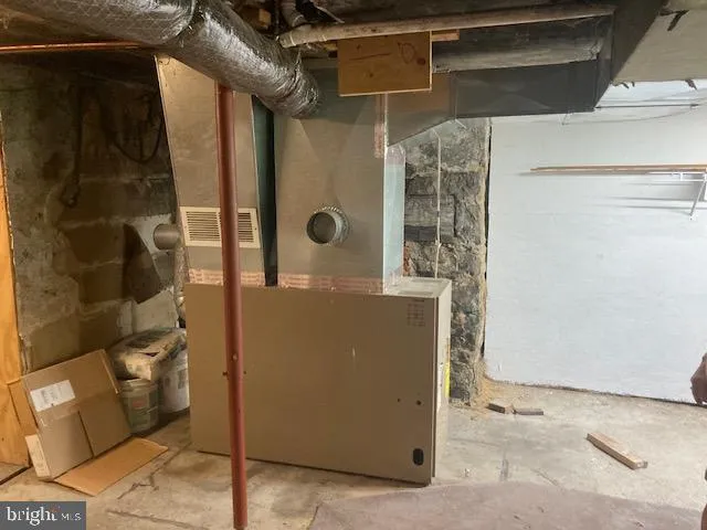 a room with furniture a refrigerator and a dresser