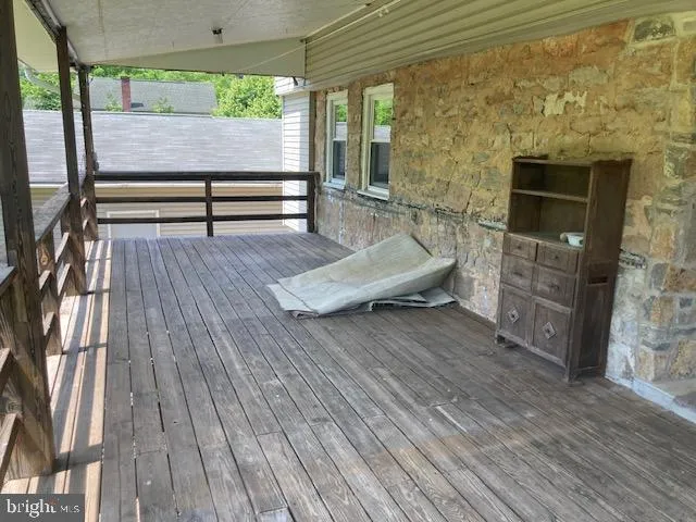a room with lots of white furniture and a chandelier