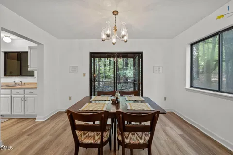 a view of a dining room with furniture wooden floor and chandelier