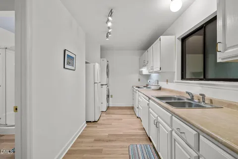 a kitchen with kitchen island a stove a sink and wooden floor