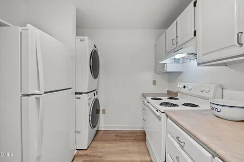 a kitchen with white cabinets and white appliances