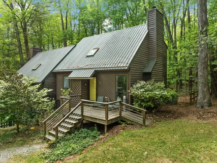 a view of a yard with plants and trees