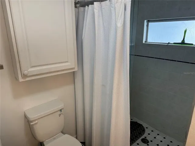 a bathroom with a toilet and shower