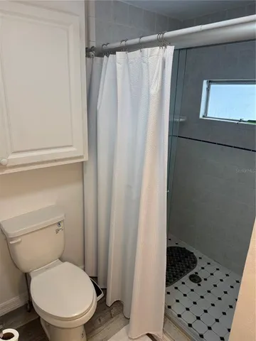 a white toilet sitting next to a white sink