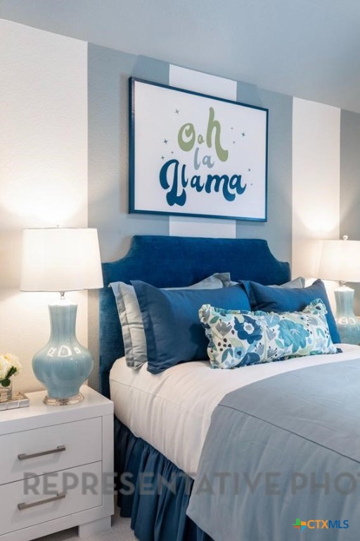 608 High Summit Drive Georgetown, TX 78628 - Photo 20 of 36 a bed sitting in a bedroom and painting on the wall