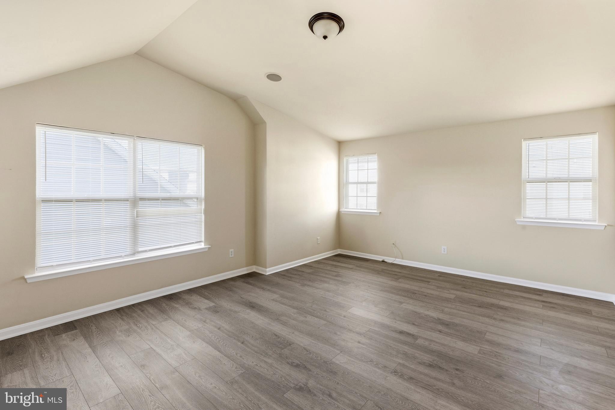 4704 Denview Way Baltimore, MD 21206 - Photo 23 of 42 an empty room with wooden floor and windows