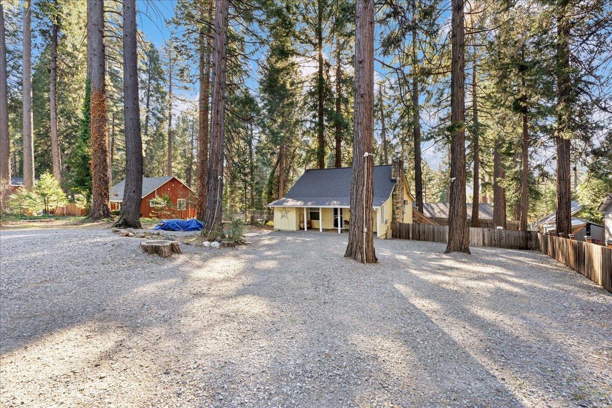 6780 Ridgeway Drive Pollock Pines, CA 95726 - Photo 25 of 27 a view of a house with a yard and sitting area