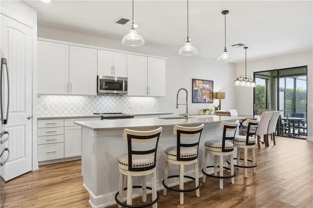 a large kitchen with a table and chairs
