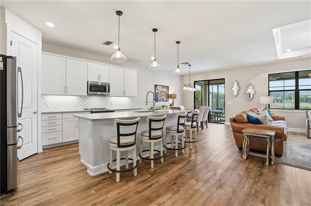 19906 Beverly Park Road Estero, FL 33928 - Photo 18 of 50 a large kitchen with a table and chairs