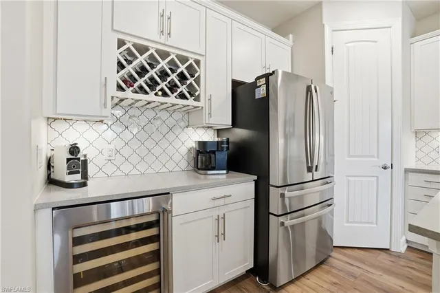 a kitchen with stainless steel appliances granite countertop a kitchen island a stove a table and chairs with wooden floor