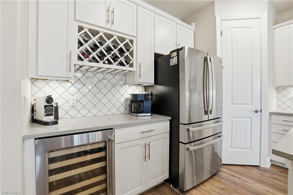 19906 Beverly Park Road Estero, FL 33928 - Photo 19 of 50 a kitchen with stainless steel appliances a refrigerator and cabinets