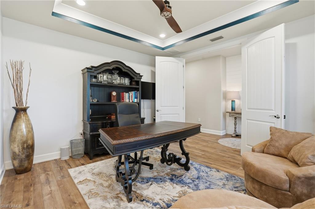 19906 Beverly Park Road Estero, FL 33928 - Photo 24 of 50 a living room with furniture and wooden floor