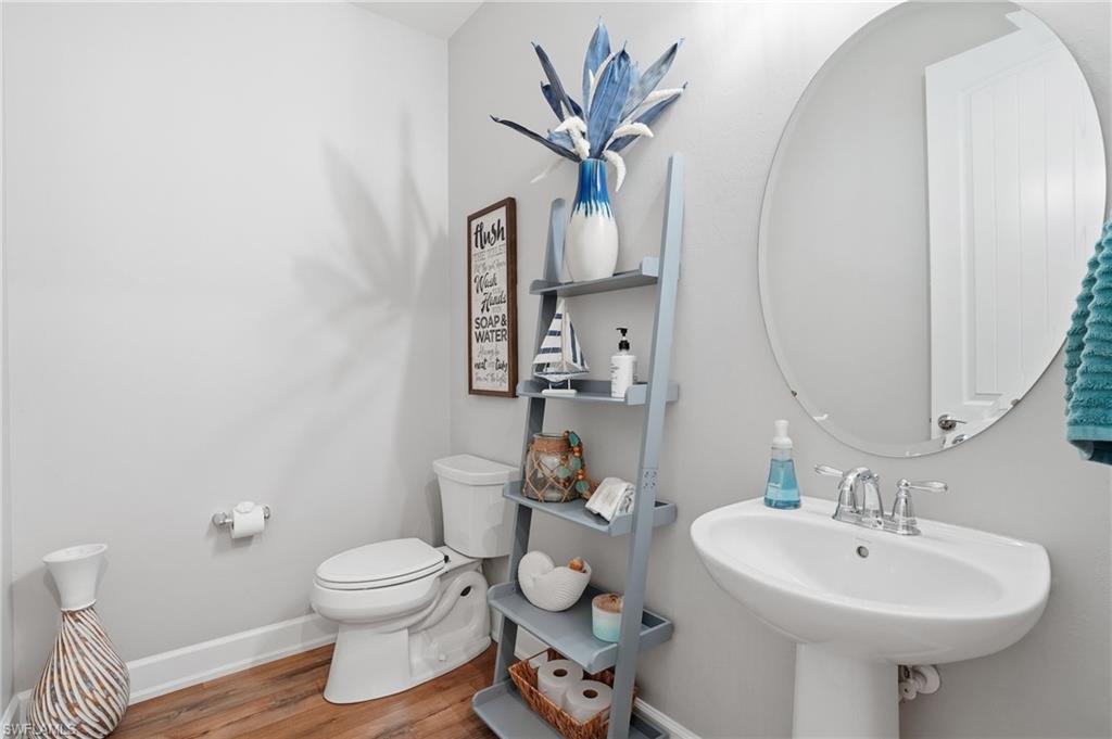 19906 Beverly Park Road Estero, FL 33928 - Photo 25 of 50 a bathroom with a toilet sink and mirror