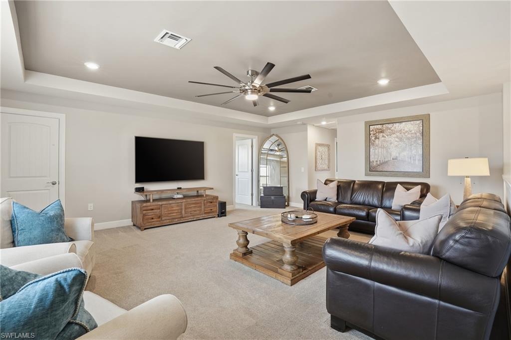 19906 Beverly Park Road Estero, FL 33928 - Photo 26 of 50 a living room with furniture and a flat screen tv