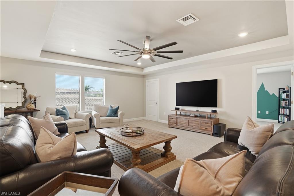 19906 Beverly Park Road Estero, FL 33928 - Photo 27 of 50 a living room with furniture and a flat screen tv