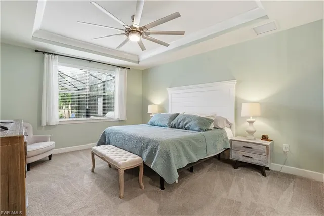 a bedroom with a bed tv and a window