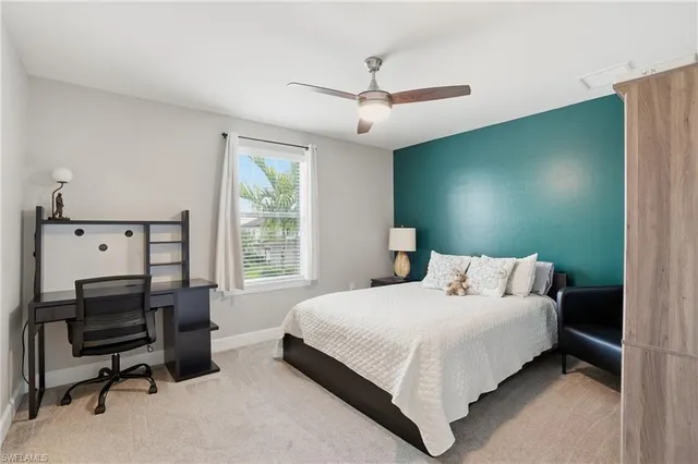 a bedroom with a bed and a book shelf