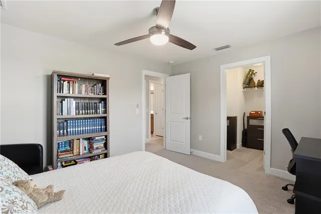 a bedroom with a bed and a lamp