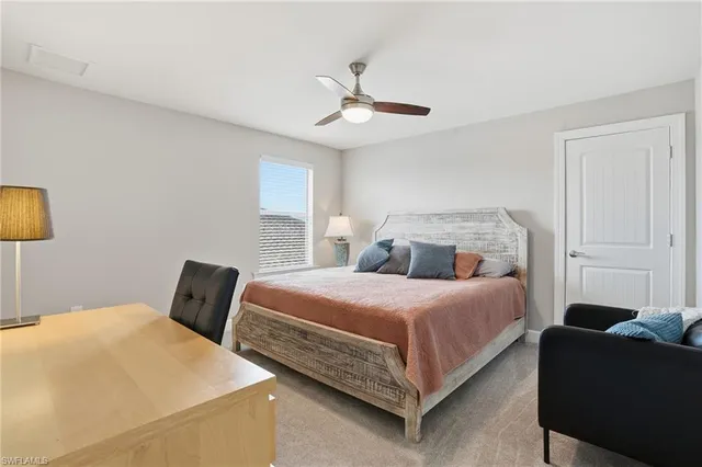 a bedroom with a bed couch and window