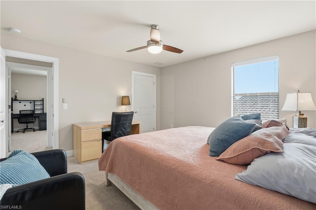 19906 Beverly Park Road Estero, FL 33928 - Photo 37 of 50 a bedroom with a bed couch and window