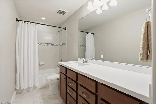 a room with white cabinets and a wooden floor