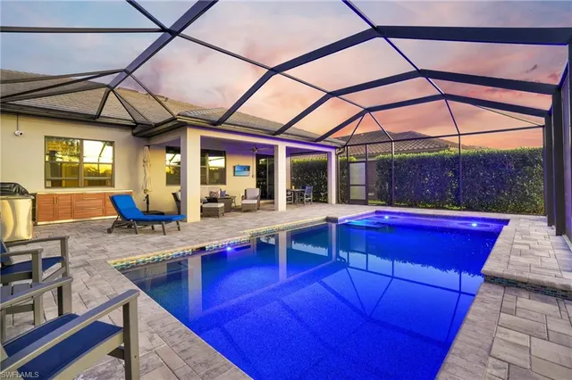 a roof deck with couch and chairs