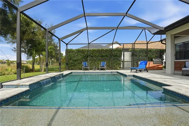 a view of a backyard patio and swimming pool